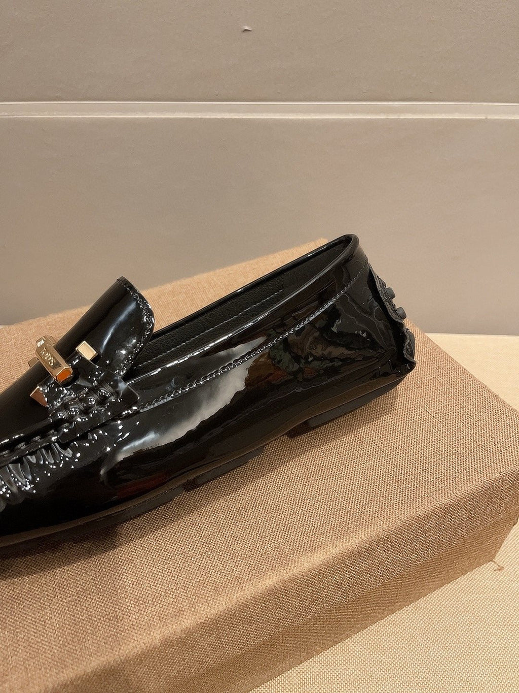 Tod's Glossy Metal Bar Loafers — detail