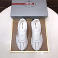 Prada Triangle Plaque Low-Top Sneakers — hero